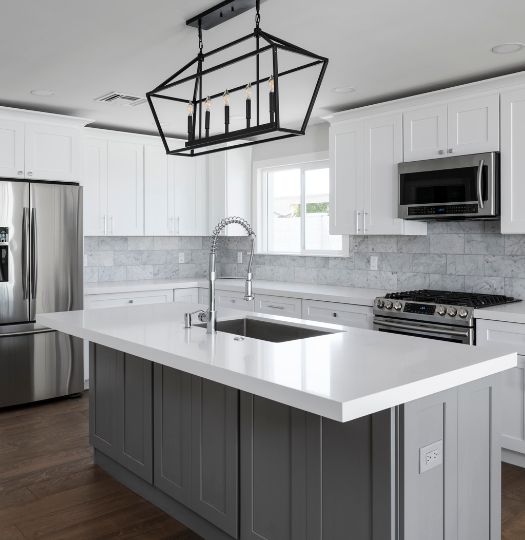 white upper cabinets and grey island